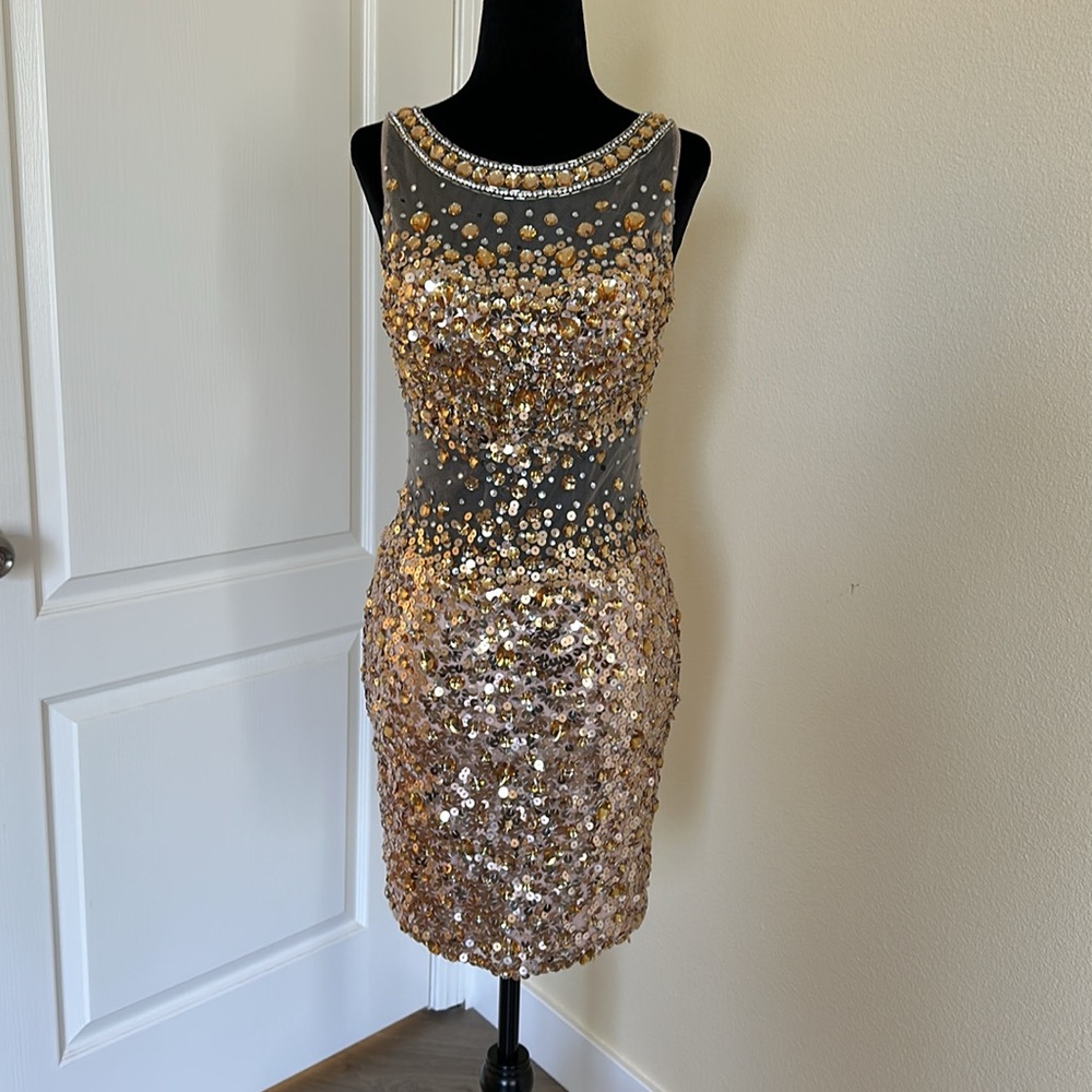 JOVANI mini illusion dress. With sheer material and gold stones. Size 2